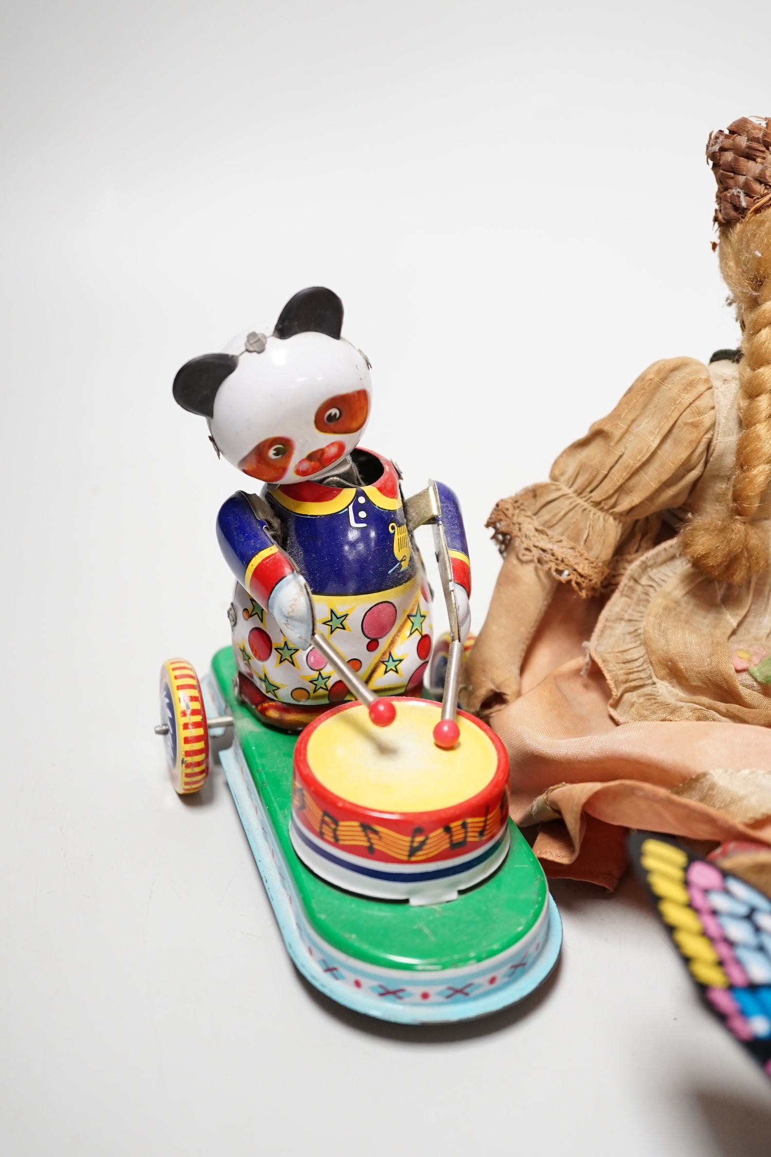 Two tin plate clockwork toys, a doll and a treen box